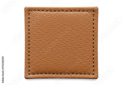 Close up of a small textured brown leather rectangle with stitched edges