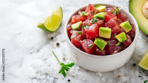 tuna tartare in a small bowl with avocado cubes,