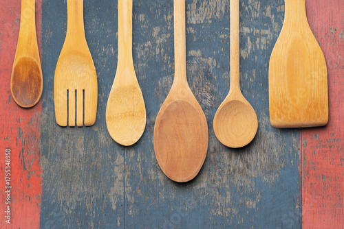 Assorted Wooden Kitchen Utensils on a Rustic Painted Wooden Background. File with Clipping Path.