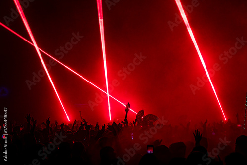Fans with Arms Waving and Fans in the Crowd at an EDM Dance Music Concert Festival Show