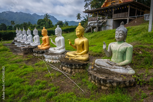 Serene Buddha sculptures in meditation pose with a traditional Thai temple background at Wat Hat Ngiew temple, Sai Yok, Kanchanaburi, Thailand 