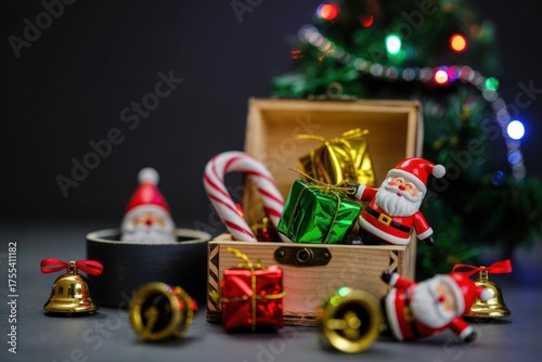 Festive Christmas Arrangement: Miniature Tree, Santa Figurines, Holiday Gifts, and Decorative Bells on Dark Background