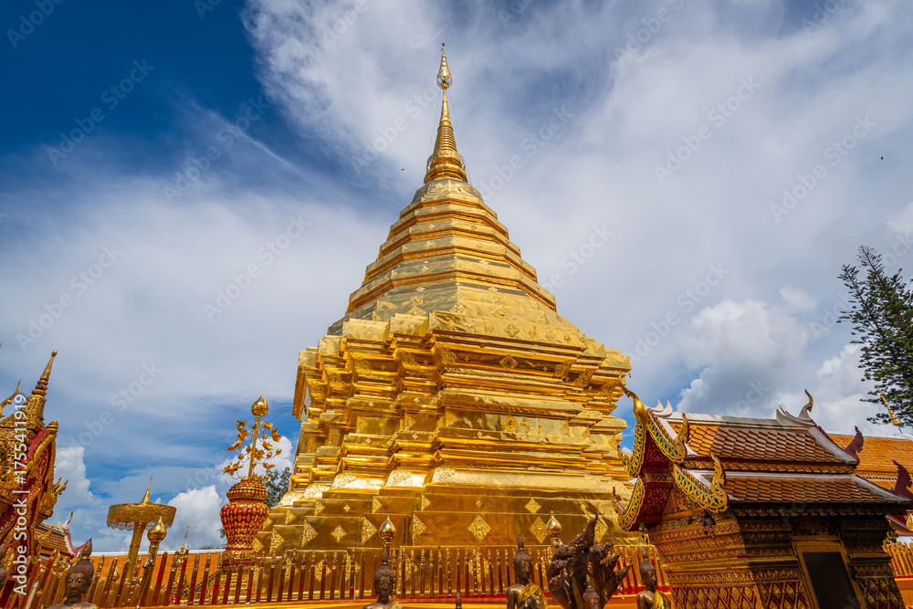 Naklejka premium The golden stupa of Wat Phra That Doi Suthep shines under the clear blue sky, a sacred symbol of Chiang Mai’s timeless beauty.
