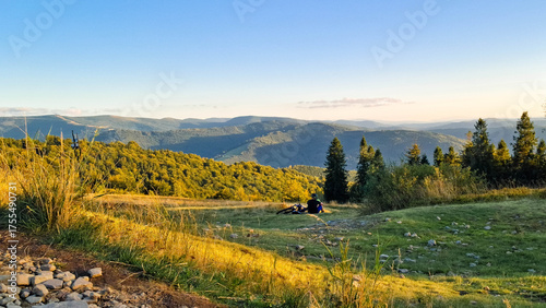 Fototapeta Naklejka Na Ścianę i Meble -  Biker relaxing on a meadow in Beskids.