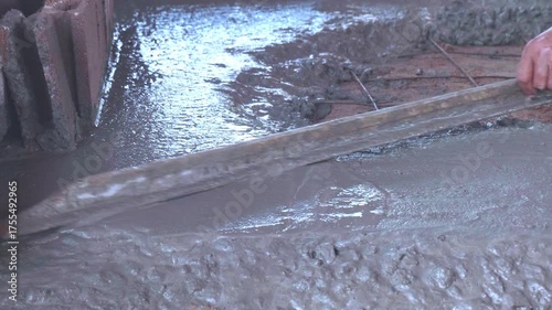 Professional workers are applying cement plaster.