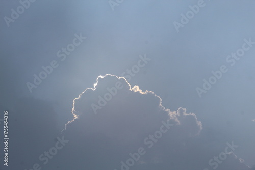 Bright Cumulus Cloud with Silver Lining Against Clear Blue Sky