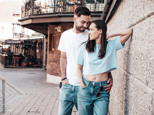 Smiling beautiful woman and her handsome boyfriend. Woman in casual summer jeans clothes. Happy cheerful family. Female having fun. Sexy couple posing in the street at sunny day