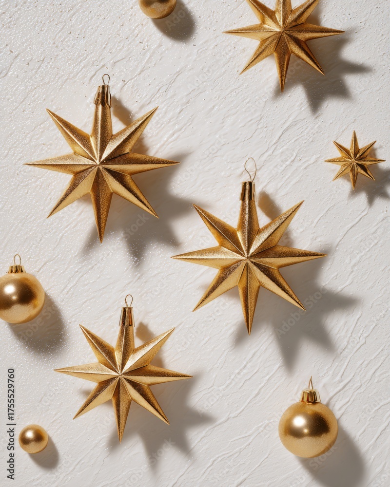 Fototapeta premium Minimal still life with gold star ornaments on white background, symbolizing celebration and festivity.