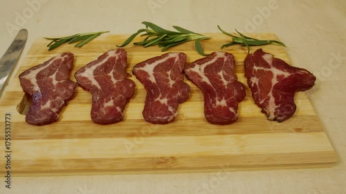 Wallpaper Mural Thinly sliced pieces of cured meat on a wooden board. Knife nearby. Concept of nutritious and tasty meat dishes, protein-rich diet and traditional cuisine Torontodigital.ca