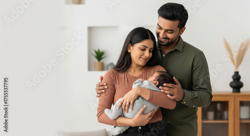Happy Indian parents bonding with their newborn baby at home