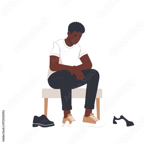 Pensive Dark Skinned Man Seated on Stool with White T Shirt and Rolled Up Dark Trousers Isolated on a Clean White Background Studio Shot