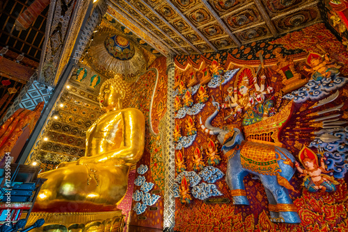 The golden Buddha statue at Wat Si Don Mun in Chiang Mai, Thailand, glows with divine beauty and rich Lanna art, creating a peaceful and spiritual atmosphere inside the temple.