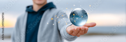 Man holding digital holographic globe with connected network nodes in futuristic technology concept