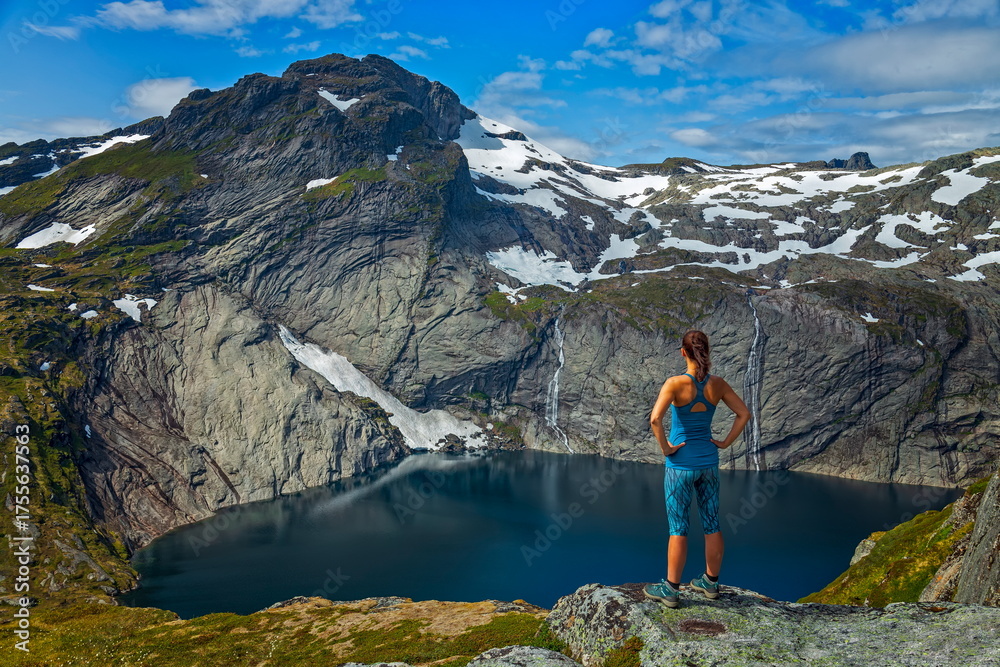 Naklejka premium Hiker Overlooking a Mountain Lake