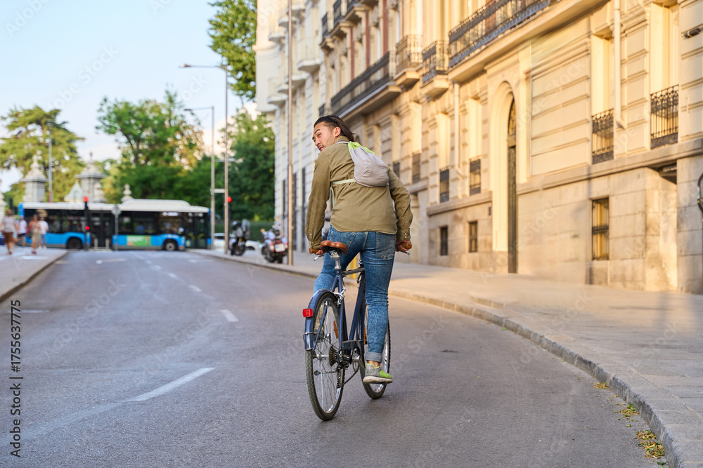 custom made wallpaper toronto digitalYoung man turning back while riding bicycle in the city street