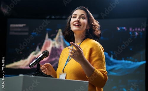 woman is giving a presentation at conference