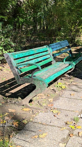 Old weathered painted bench in city park – symbol of urban renewal, park restoration and sustainable urban design planning