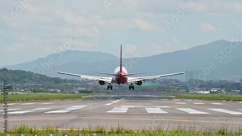 4K Back view of airplane touching down runway with smoke