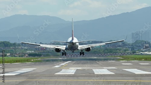4K Passenger plane lands on the runway with smoke comes from under the wheels