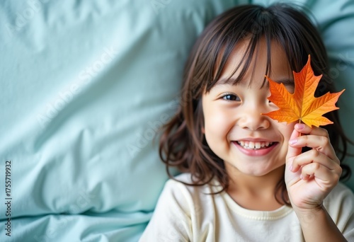 Autumn mood, happy smiling girl closes her eye with fall maple leaf, on blue textile background, promo poster template for seasonal autumn marketing, sale