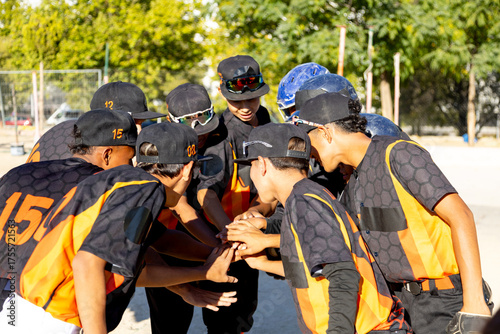 Photography Youth baseball team players huddling up before game