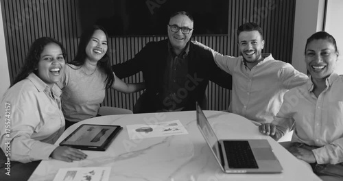 Multiracial business people celebrating success inside modern corporate office - Job, support and team concept - Black and white editing
