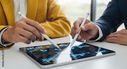 Digital transformation consulting, Two professionals collaborate using digital tablets, analyzing data and charts displayed on the screens, teamwork and modern technology.
