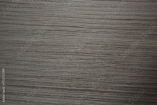 Construction and renovation materials, natural wood background. Gray-brown plastic surface with the texture and relief of wooden planks.