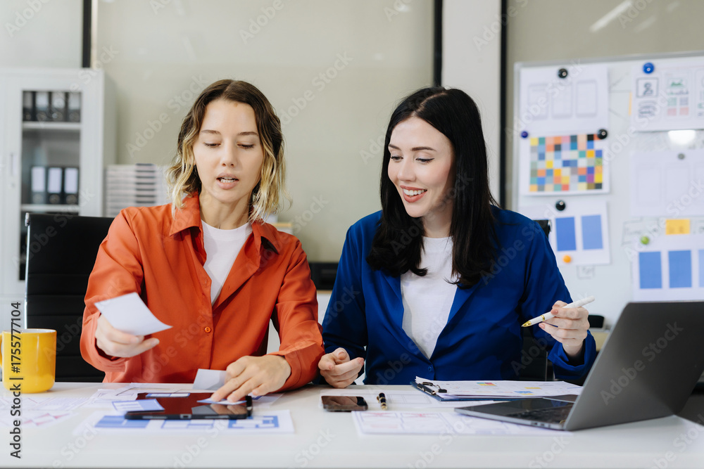 Fototapeta premium Creative digital development agency. developer team brainstorming on their project with laptop, smartphone and digital tablet.