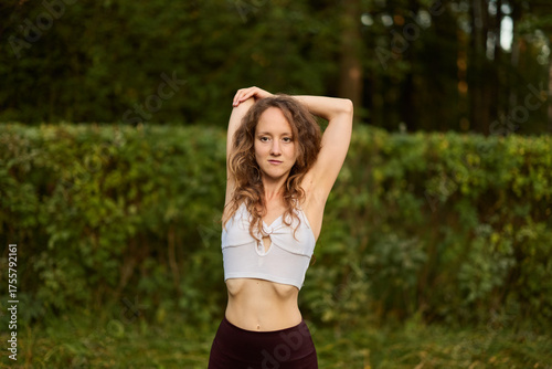 A Woman Beautifully Stretching in Nature During the Amazing Golden Hour of the Day