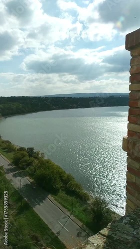 Fortification architecture in Petrovaradin: small brick watchtower, Danube River and Upper Fortress defensive walls. Military architecture detail. Iconic landmarks of Serbia and tourism in Novi Sad.