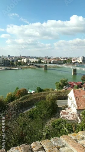 Panoramic view from Upper Petrovaradin Fortress with river, Varadin Bridge, and Novi Sad skyline. Concepts of city harmony, scenic Serbian destinations, Europe exploration. Attractions on the Danube.