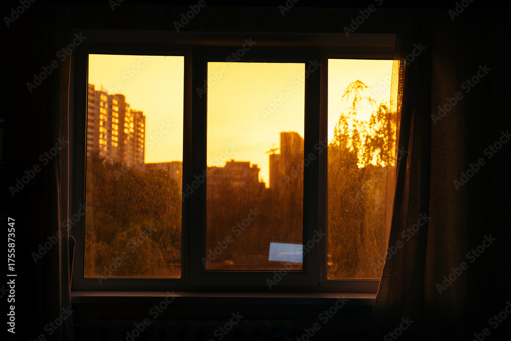 Fototapeta premium City sunrise view through window