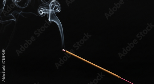 Aromatic incense stick burning with smoke on, creating a calming and meditative atmosphere for relaxation and spiritual practices