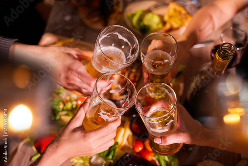  Friends having fun clinking glasses with beer