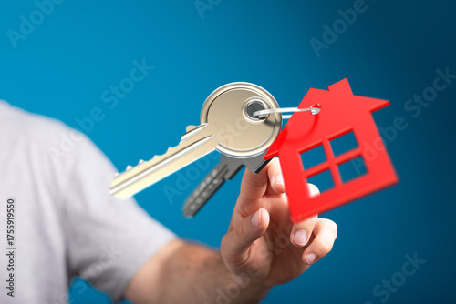 A person holds house keys w...