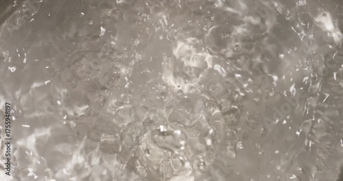 boiling water texture closeup on electric stove, food closeup top view