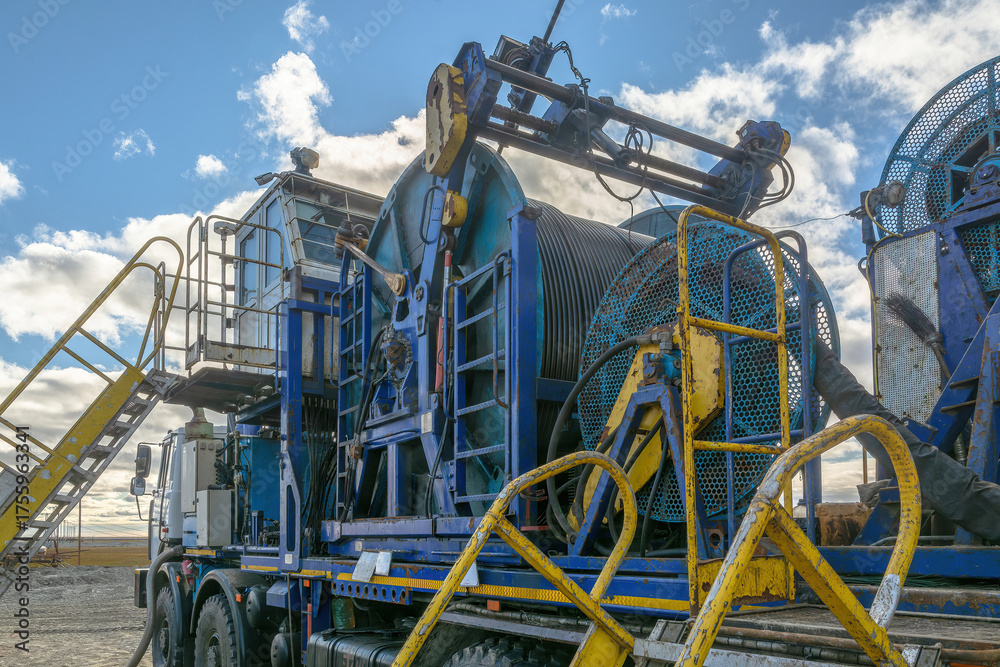 Fototapeta premium The Northern gas field. Summer. Installation for lowering a flexible pipe into a well. Equipment for testing and development of a gas well