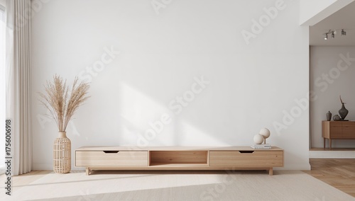 Interior of a minimalist white room featuring natural wooden furniture against a plain wall