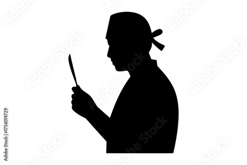 Silhouette of surgeon in profile holding surgical instrument