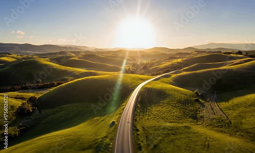 Aerial View of a Serene Road Winding Through Lush Green Hills at Sunset, Tuscany Landscape