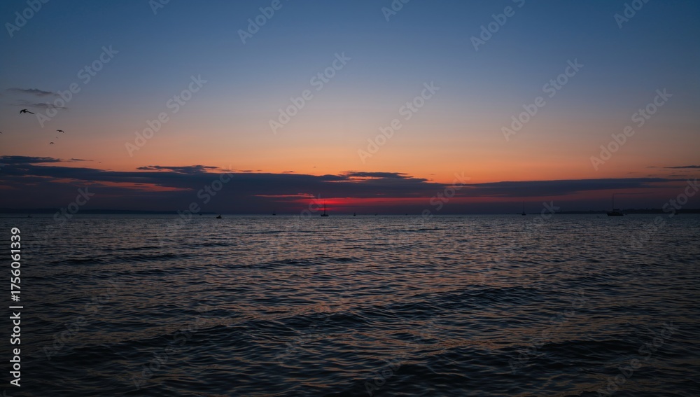 Fototapeta premium Stunning dusky sky above tranquil, level waters