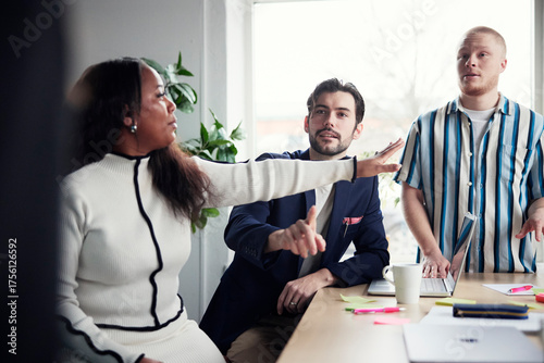 Wallpaper Mural Female manager interrupting male colleagues discussing in debate at office Torontodigital.ca