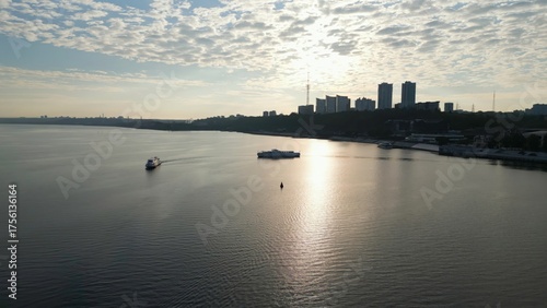 Vászonkép Passenger ferry approaching another ferry on dnipro river at sunrise
