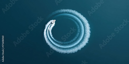 Speedboat circle wake pattern on deep blue sea, aerial view showing boat trail, spray, motion and contrast with calm water creating energetic and dramatic scene