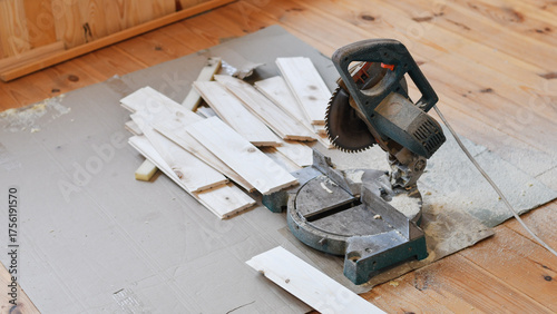 Miter Saw and Cut Lumber on Wooden Floor – DIY Carpentry Project in Progress