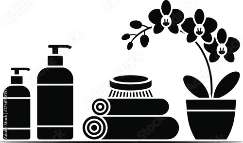 Spa and wellness items including lotion bottles towels brush and orchid plant