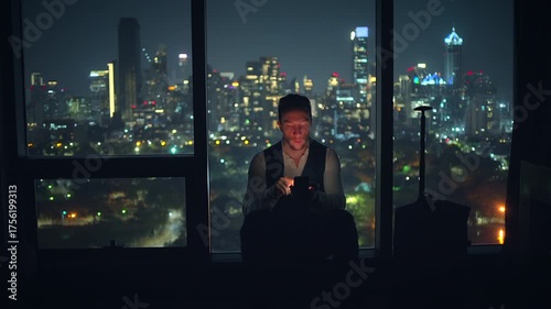 Wallpaper Mural A contemplative figure stands thoughtfully against a vibrant night cityscape filled with lights Torontodigital.ca