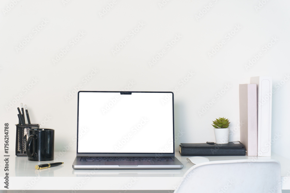 Fototapeta premium Laptop, book and coffee cup on white desk, blank screen ready for design or presentation.