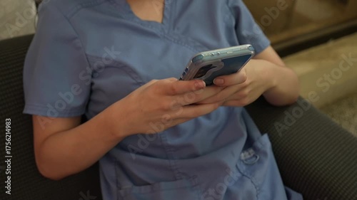 young girl in purple uniform using her cell phone